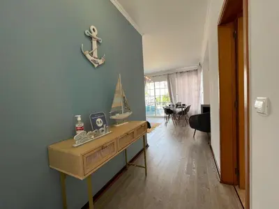 a room with a wooden dresser with a ship on the wall at Casa Do Pico by AnaLodges in Machico