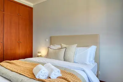a bedroom with a bed with towels on it at Forum Escape, a Home in Madeira in Funchal