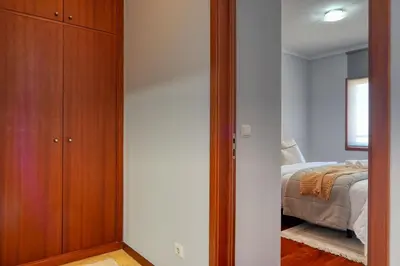 a bedroom with a closet and a bed at Forum Escape, a Home in Madeira in Funchal