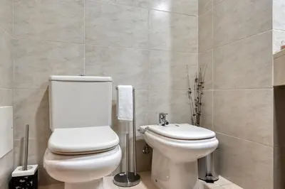 a bathroom with a toilet and a sink at Forum Escape, a Home in Madeira in Funchal
