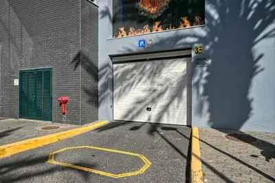 a garage door with a fire hydrant in front of a building at Forum Escape, a Home in Madeira in Funchal