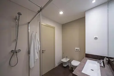 a bathroom with a sink and a shower and a toilet at Madeira Palace I by An Island Apart in Funchal
