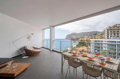 a dining room with a view of the ocean at Madeira Palace I by An Island Apart in Funchal