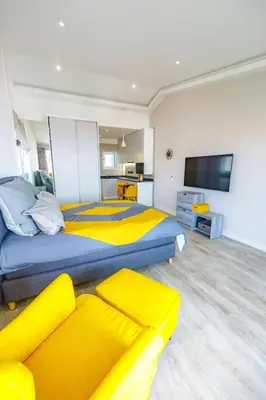 a large room with two beds and a television at Vista Oceano III in Caniço