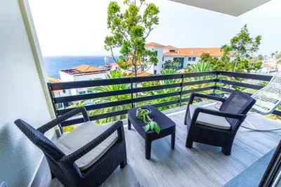 a balcony with chairs and a toy turtle on it at Vista Oceano III in Caniço