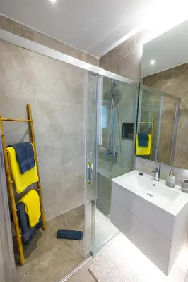 a bathroom with a sink and a glass shower at Vista Oceano III in Caniço