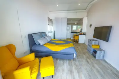 a bedroom with a bed and a tv and a couch at Vista Oceano III in Caniço