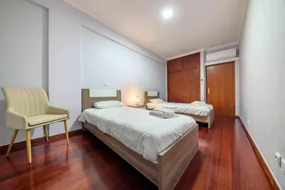 a bedroom with two beds and a chair in it at Alex Apartment by Mth in Funchal