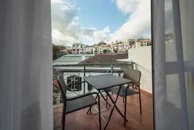 a balcony with a table and chairs on a balcony at Alex Apartment by Mth in Funchal