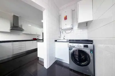 a white kitchen with a washing machine in it at Alex Apartment by Mth in Funchal