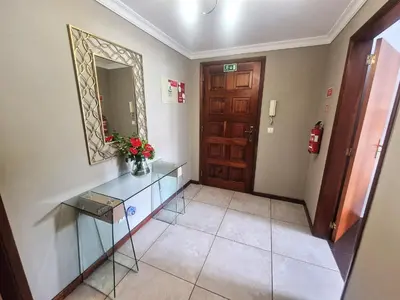 a hallway with a glass table and a mirror at Alex Apartment by Mth in Funchal