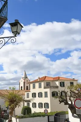 a building with a clock tower on top of it at Alojamento Príncipe D.Luís in Ponta do Sol