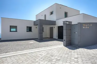 a white building with a sign that says skyfall wine at SKYFALL VILLA in Arco da Calheta