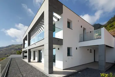 a white house with a large letter k on it at SKYFALL VILLA in Arco da Calheta