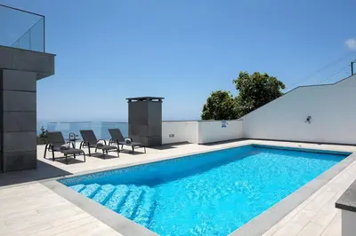 a swimming pool on the roof of a house at SKYFALL VILLA in Arco da Calheta
