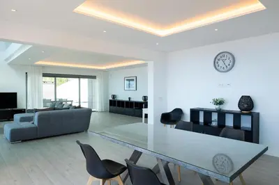 a living room with a table and a couch at SKYFALL VILLA in Arco da Calheta