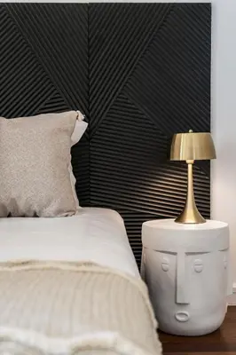 a bedroom with a bed and a lamp on a night stand at Quinta da Falésia II by An Island Apart in Funchal