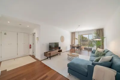 a living room with a blue couch and a tv at Quinta da Falésia II by An Island Apart in Funchal