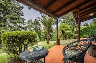 a patio with a table and chairs on a porch at Villa Achada da Mouca by Homie in Santana