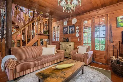 a living room with two couches and a table at Villa Achada da Mouca by Homie in Santana