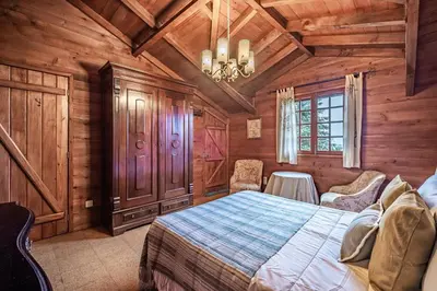 a bedroom with a bed in a wooden room at Villa Achada da Mouca by Homie in Santana
