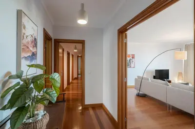 a hallway with a living room with a couch and a tv at Monumental Place by An Island Apart in Funchal