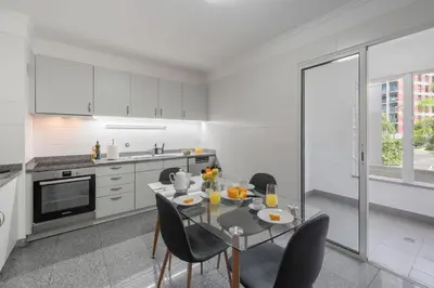 a kitchen with a table and chairs in a kitchen at Monumental Place by An Island Apart in Funchal