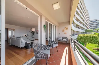 a balcony with chairs and a living room at Monumental Place by An Island Apart in Funchal