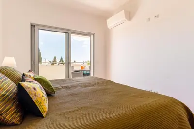 a bedroom with a bed with a large window at Spacious 2 bedroom Apartment with Sea View Lagos by Lisbeyond in Lagos