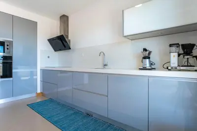 a kitchen and living room with a table and chairs at Spacious 2 bedroom Apartment with Sea View Lagos by Lisbeyond in Lagos
