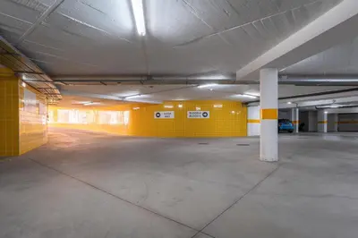 an empty parking garage with a yellow wall at Spacious 2 bedroom Apartment with Sea View Lagos by Lisbeyond in Lagos