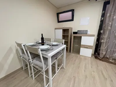 a dining room with a white table and chairs at Beautiful View 1 - Arco da Calheta - Ilha da Madeira in Arco da Calheta
