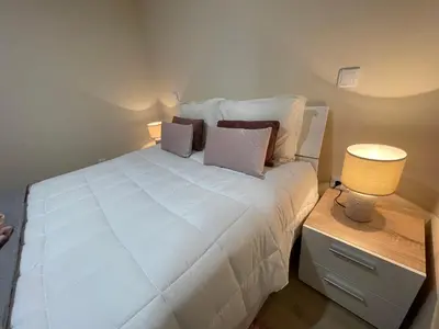 a bedroom with a large white bed with two lamps at Beautiful View 1 - Arco da Calheta - Ilha da Madeira in Arco da Calheta
