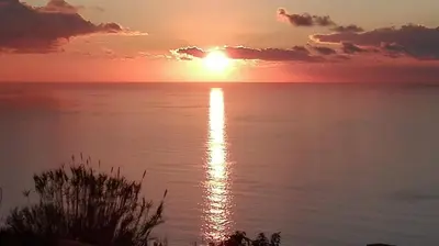 a sunset over the ocean with the sun reflecting in the water at Beautiful View 1 - Arco da Calheta - Ilha da Madeira in Arco da Calheta