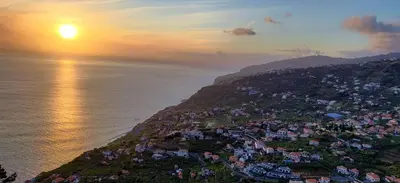 an aerial view of a town on a hill next to the ocean at Maison Du Soleil in Arco da Calheta