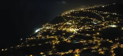 a view of a city lit up at night at Maison Du Soleil in Arco da Calheta