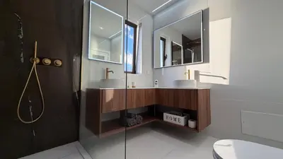 a kitchen with white cabinets and black chairs at Maison Du Soleil in Arco da Calheta
