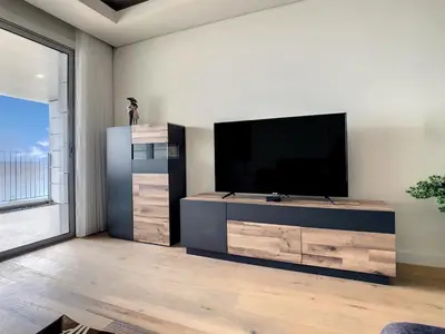 a living room with a flat screen tv on a wall at The Best Sea View Apartment by LovelyStay in Funchal