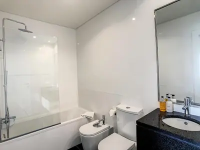 a white bathroom with a toilet and a sink at The Best Sea View Apartment by LovelyStay in Funchal