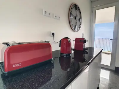 a kitchen with a red toaster on a counter at The Best Sea View Apartment by LovelyStay in Funchal