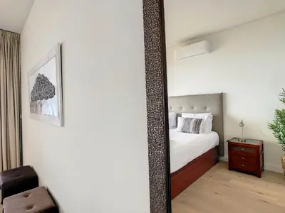 a mirror in a bedroom with a bed and a chair at The Best Sea View Apartment by LovelyStay in Funchal