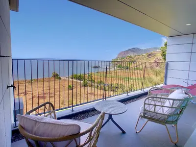 a balcony with a table and chairs and a view at The Best Sea View Apartment by LovelyStay in Funchal
