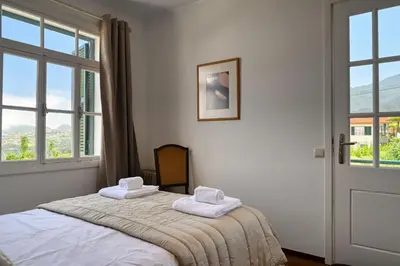 a bedroom with a bed with two towels on it at Os Ferreirinhos, a Home in Madeira in São Jorge