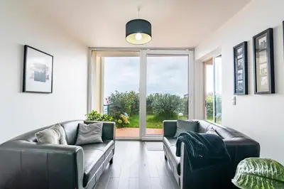 a living room with two couches and a large window at Villa Valeriu in Santa Cruz