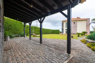 a pavilion with a brick walkway in front of a house at Villa Valeriu in Santa Cruz