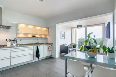a kitchen and dining room with a table and chairs at Villa Valeriu in Santa Cruz