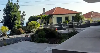 a house with a porch and a driveway at Casa Magic Vieira New well located with services in Arco da Calheta