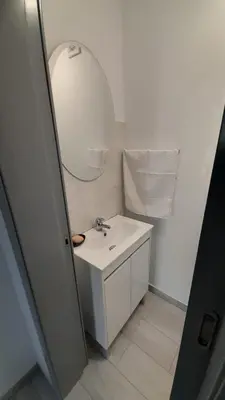 a white bathroom with a sink and a mirror at Casa Magic Vieira New well located with services in Arco da Calheta