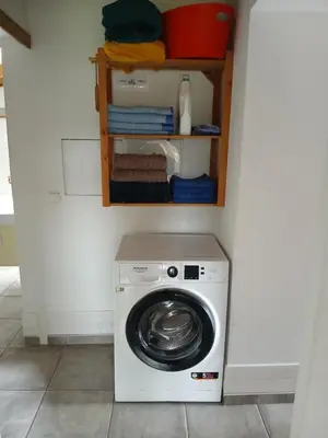 a washer and dryer in a laundry room at Casinha do Barreiro - Cosy Private Cottage in Vila do Porto