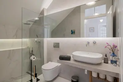 a bathroom with a toilet and a sink and a shower at OurMadeira - Chill Garden Apartment in Funchal